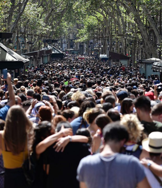 People crowd the Rambla boulevard after observing a minute of silence for the victims of the Barcelona attack at Plaza de Catalunya on August 18, 2017, a day after a van ploughed into the crowd, killing 13 persons and injuring over 100 on the Rambla in Barcelona.
Drivers have ploughed on August 17, 2017 into pedestrians in two quick-succession, separate attacks in Barcelona and another popular Spanish seaside city, leaving 13 people dead and injuring more than 100 others. In the first incident, which was claimed by the Islamic State group, a white van sped into a street packed full of tourists in central Barcelona on Thursday afternoon, knocking people out of the way and killing 13 in a scene of chaos and horror. Some eight hours later in Cambrils, a city 120 kilometres south of Barcelona, an Audi A3 car rammed into pedestrians, injuring six civilians -- one of them critical -- and a police officer, authorities said. / AFP PHOTO / JAVIER SORIANO        (Photo credit should read JAVIER SORIANO/AFP/Getty Images)